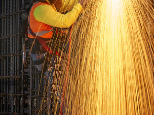 Welder Working on the Construction of The Grand, Bright Orange Sparks